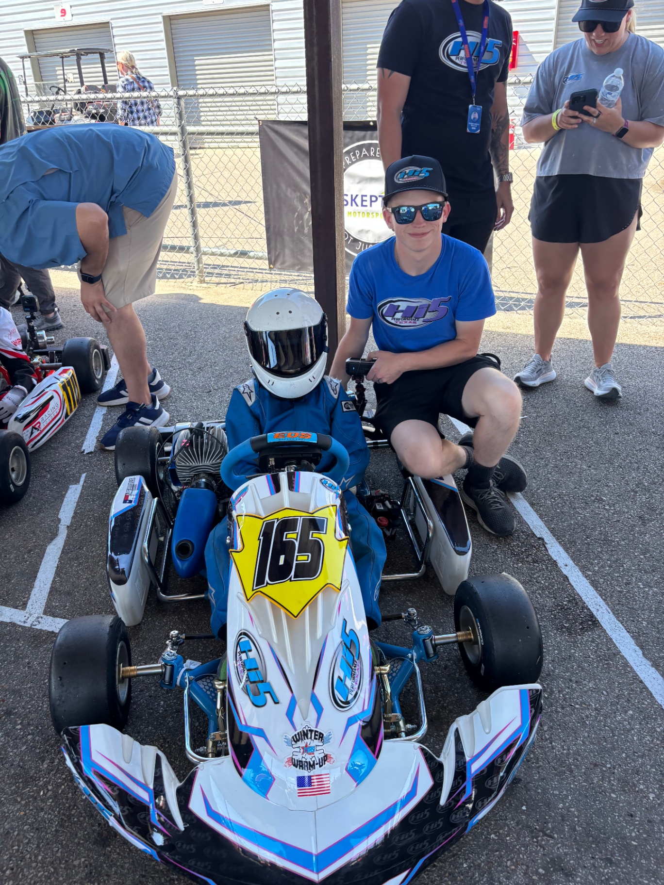 Driver and tuner on the grid before a session
